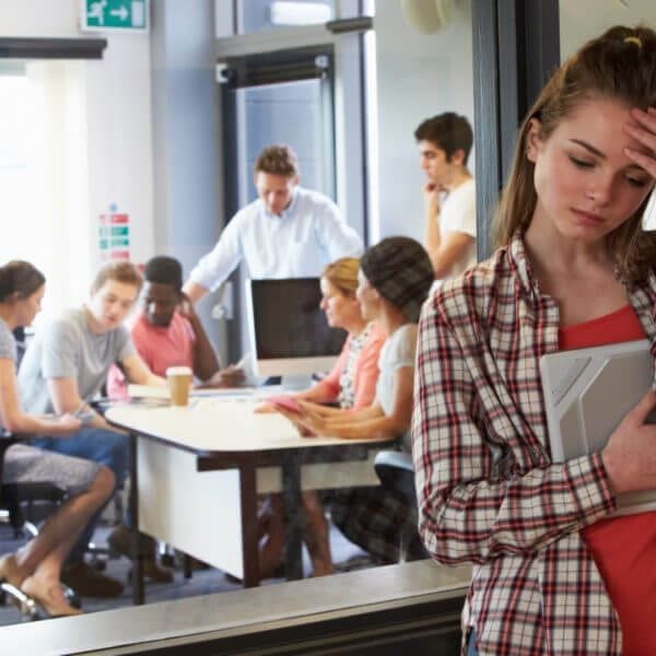 Worried Female Student Waiting Outside College Tutorial