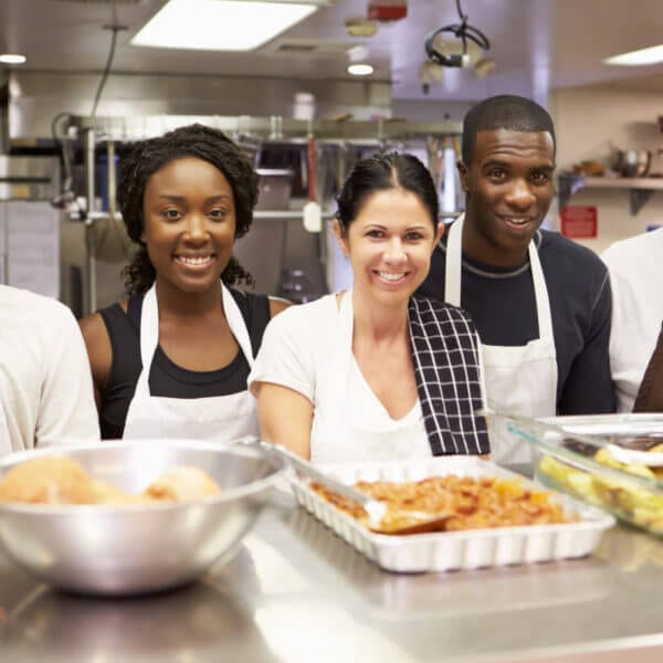 Portrait Of Kitchen Staff In Homeless Shelter Volunteering for Thanksgiving