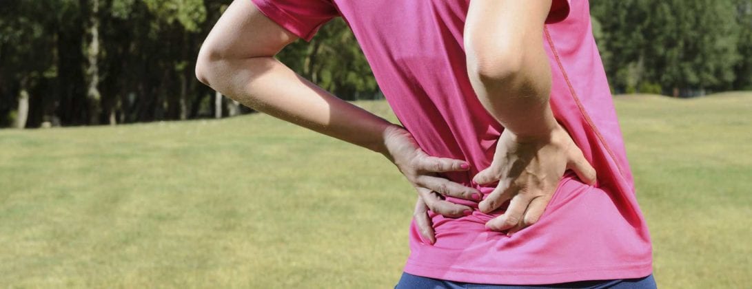 Person Clutching Back in Pain