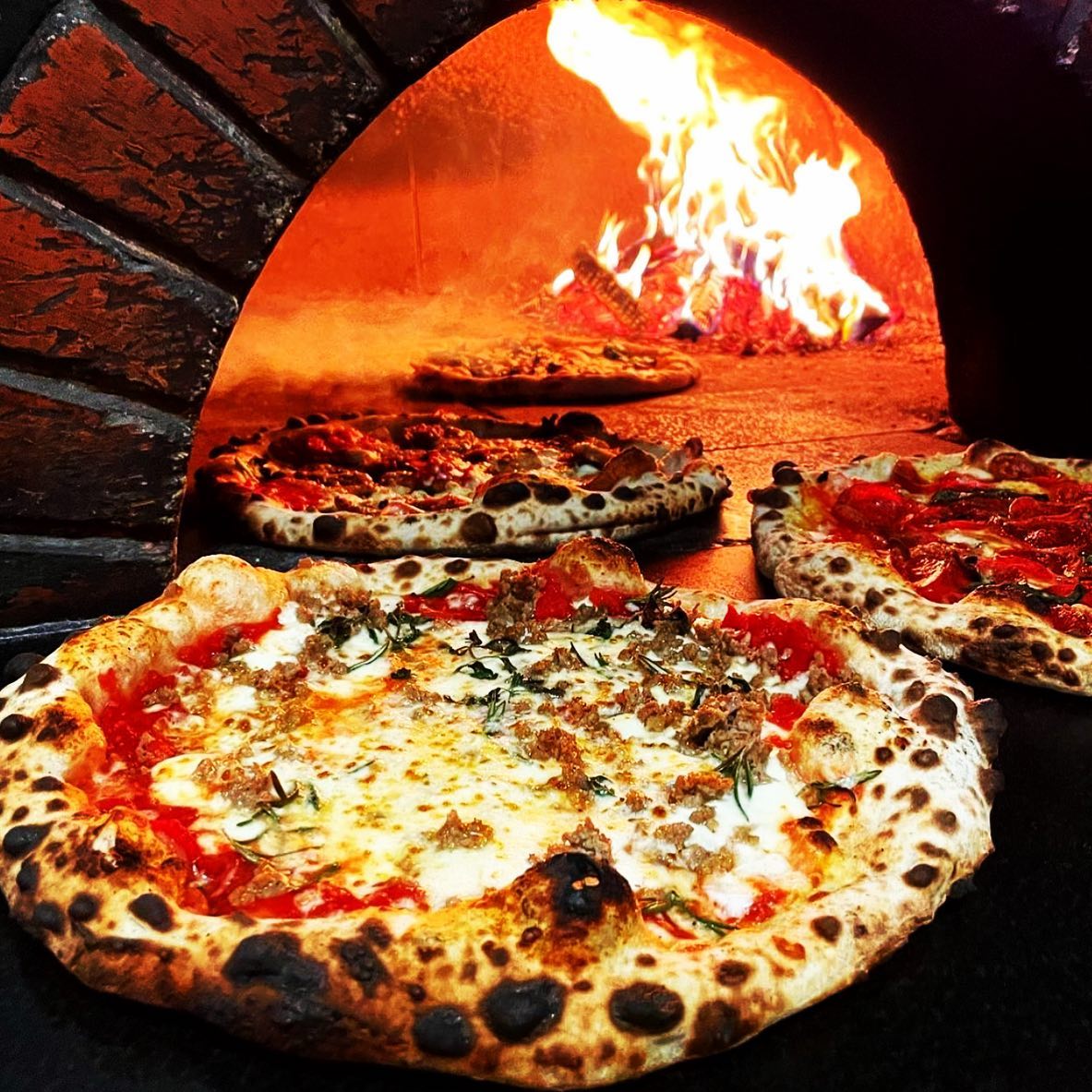 Pizza cooking in wood fire oven